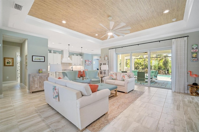 living room with ceiling fan, crown molding, a tray ceiling, and wooden ceiling