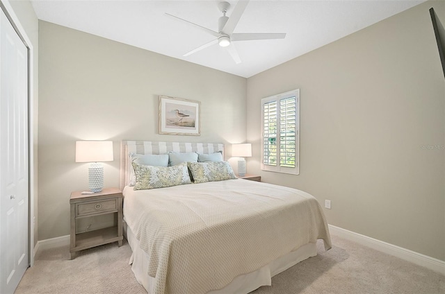 carpeted bedroom featuring ceiling fan and a closet