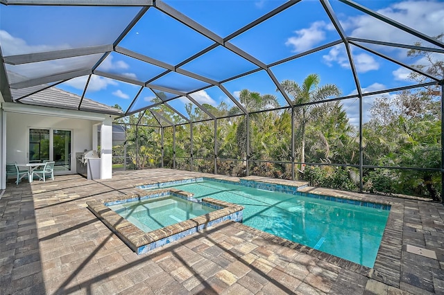 view of swimming pool with a patio, glass enclosure, and an in ground hot tub