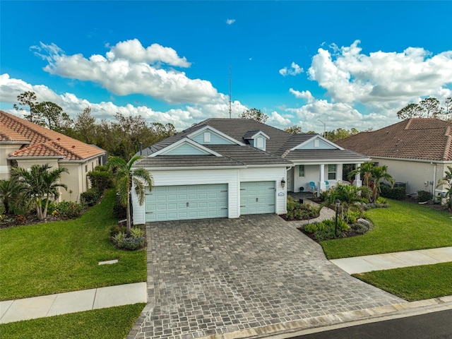 view of front of property with a garage and a front lawn