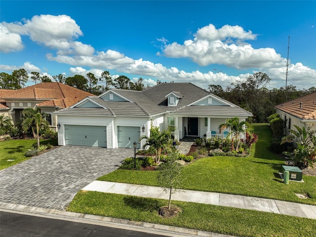 view of front facade featuring a garage, a front yard, and a porch