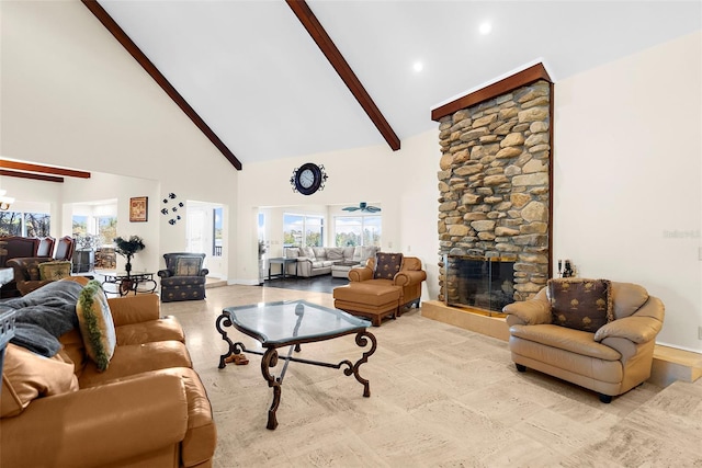 living room featuring beam ceiling, a stone fireplace, high vaulted ceiling, and ceiling fan