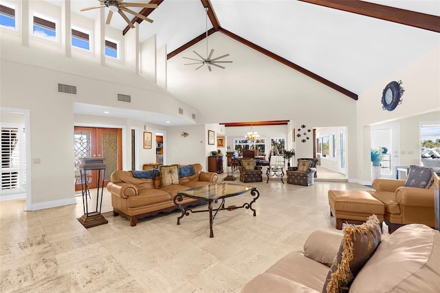 living room with high vaulted ceiling, baseboards, visible vents, and ceiling fan with notable chandelier