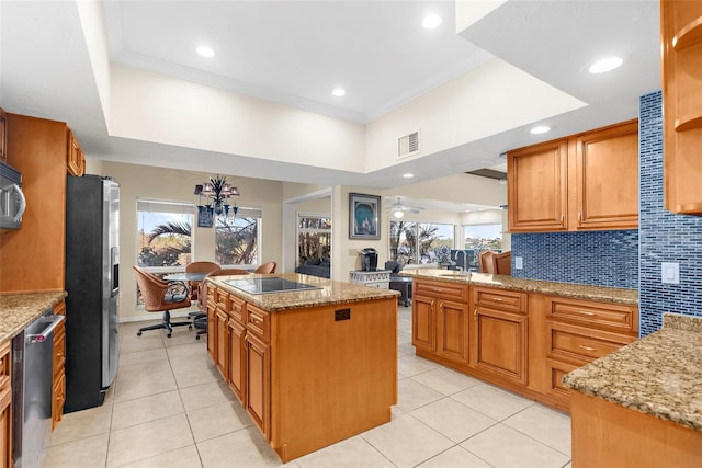 kitchen featuring a sink, light tile patterned flooring, visible vents, a kitchen island, and appliances with stainless steel finishes