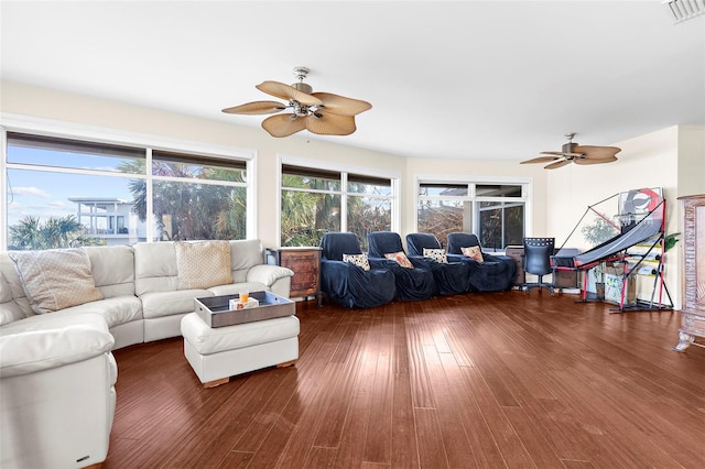 living room featuring dark wood-type flooring and ceiling fan