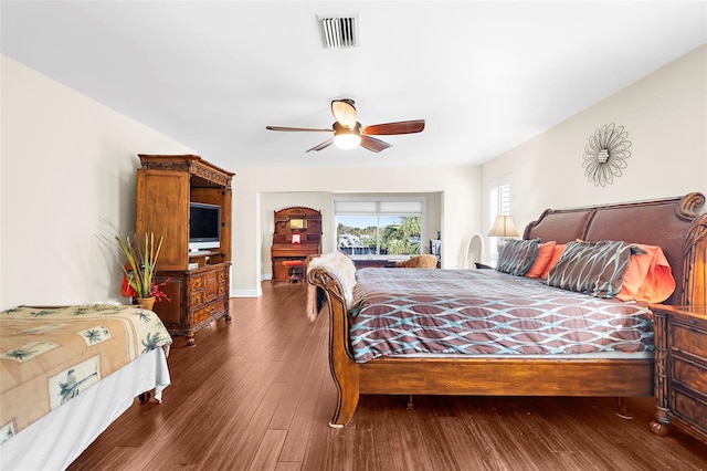 bedroom with dark wood-type flooring and ceiling fan