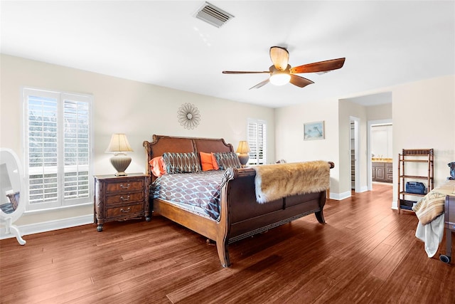 bedroom featuring ceiling fan, ensuite bath, and hardwood / wood-style floors