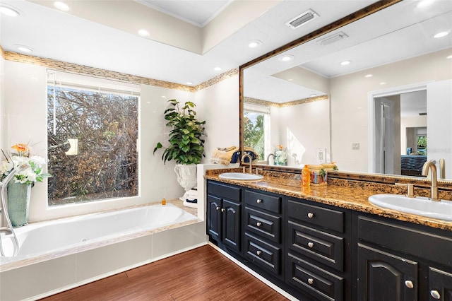 bathroom featuring a sink, visible vents, and plenty of natural light