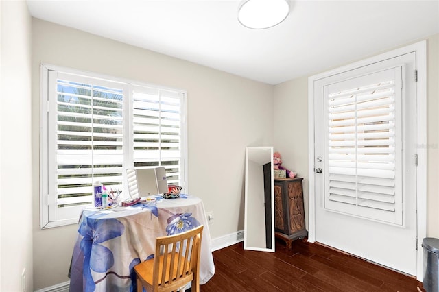 dining room featuring baseboards and wood finished floors