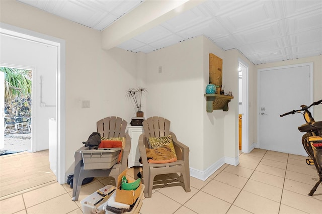 sitting room with light tile patterned flooring and baseboards