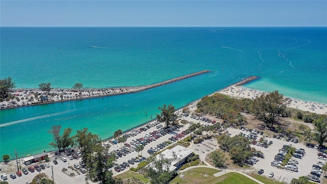 birds eye view of property featuring a water view and a beach view