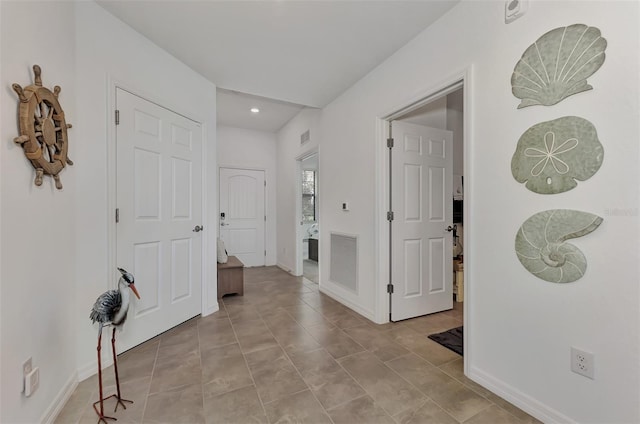 hallway featuring light tile patterned flooring