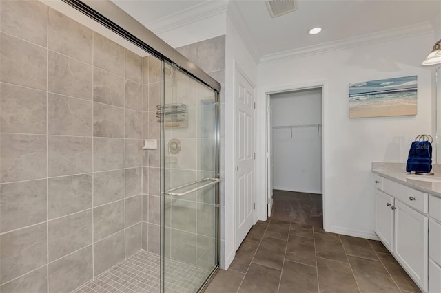 bathroom featuring vanity, crown molding, tile patterned floors, and an enclosed shower