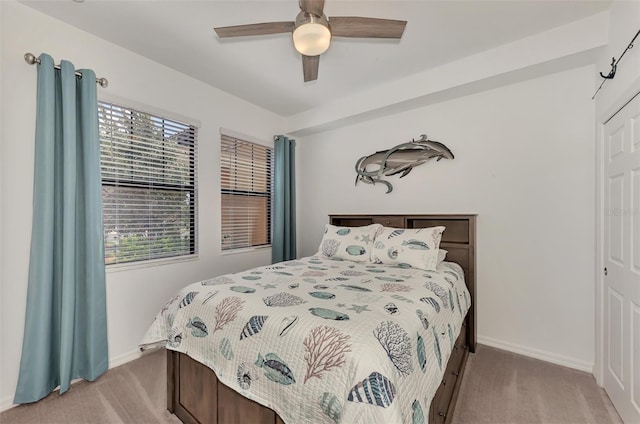 carpeted bedroom featuring a closet and ceiling fan