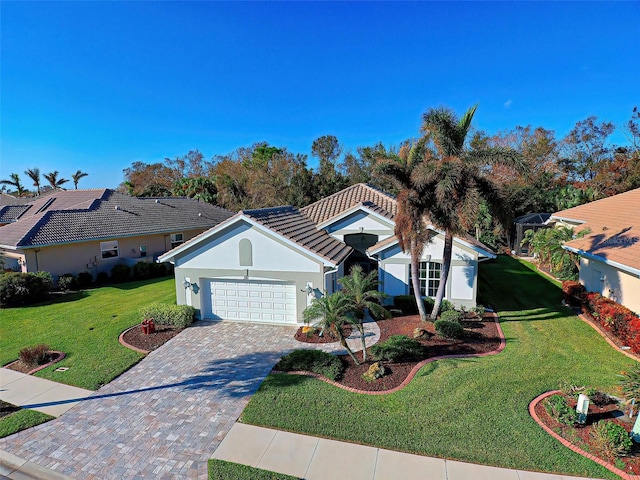 view of front of house with a front yard and a garage