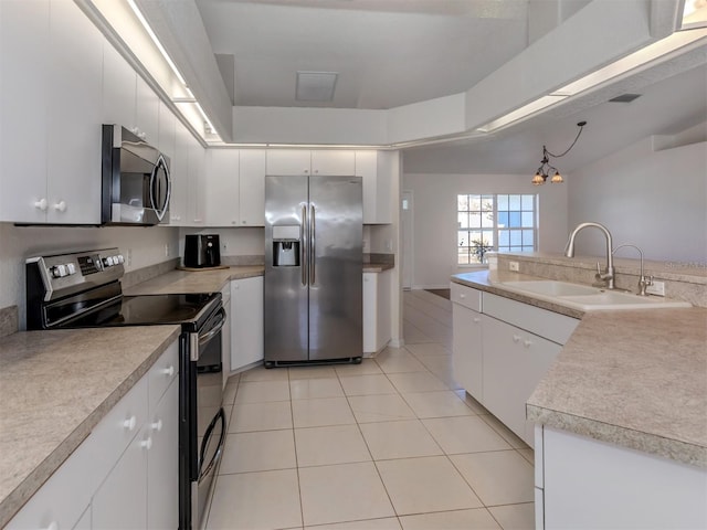 kitchen featuring stainless steel appliances, sink, and white cabinets