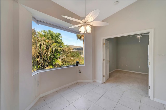 unfurnished room with ceiling fan, light tile patterned flooring, and lofted ceiling