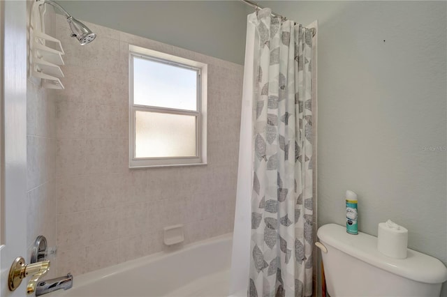 bathroom with toilet and shower / bath combo with shower curtain