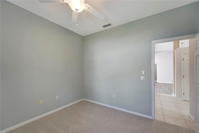 carpeted empty room featuring ceiling fan