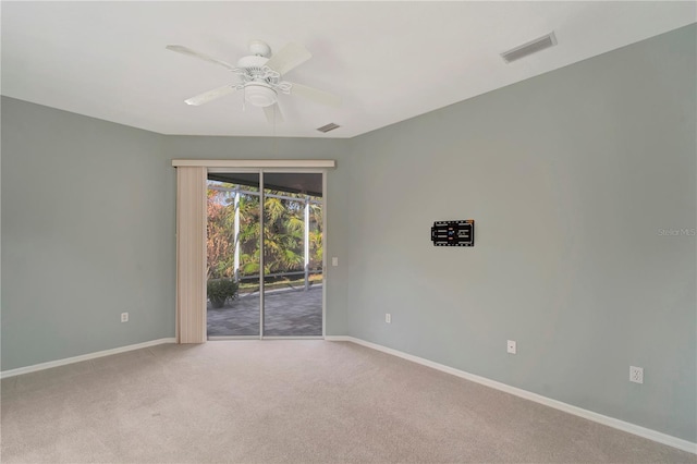 carpeted spare room with ceiling fan