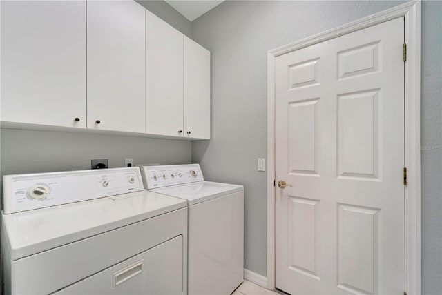 washroom with cabinets, separate washer and dryer, and light tile patterned flooring