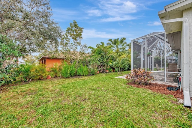 view of yard with glass enclosure