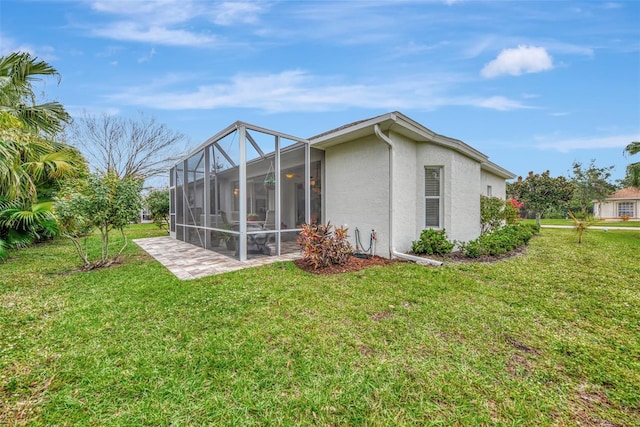 back of property featuring a lanai, a yard, and a patio