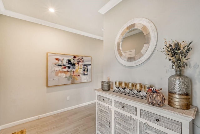 interior space featuring crown molding and light wood-type flooring