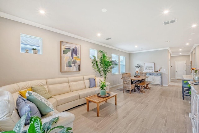 living room with ornamental molding and light hardwood / wood-style floors