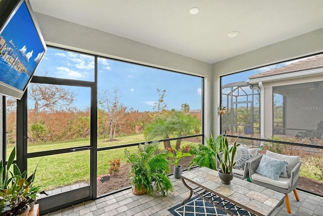 sunroom / solarium featuring a healthy amount of sunlight