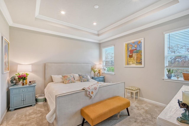 carpeted bedroom featuring ornamental molding and a raised ceiling