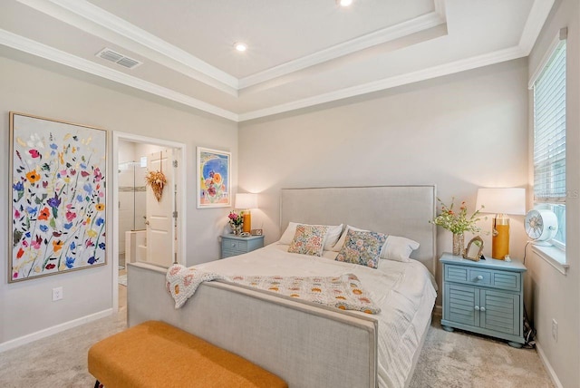 carpeted bedroom featuring a spacious closet, ensuite bath, ornamental molding, and a tray ceiling