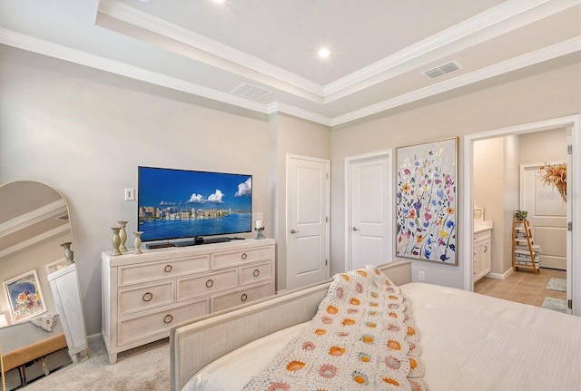 tiled bedroom featuring connected bathroom, ornamental molding, and a tray ceiling