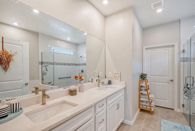 bathroom with vanity, tile patterned floors, and walk in shower