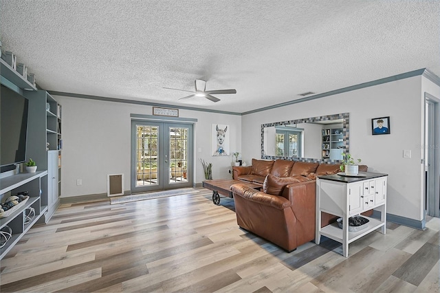 living room with french doors, a textured ceiling, light hardwood / wood-style floors, and ceiling fan