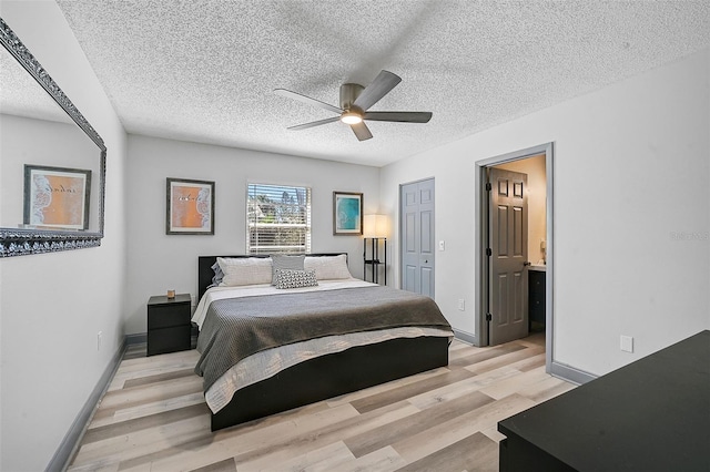 6738 Brentford Rd, Sarasota, FL 34241 - bedroom with light wood finished floors, a textured ceiling, ceiling fan, and ensuite bathroom