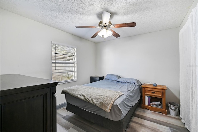 6738 Brentford Rd, Sarasota, FL 34241 - bedroom with wood finished floors, a textured ceiling, and ceiling fan