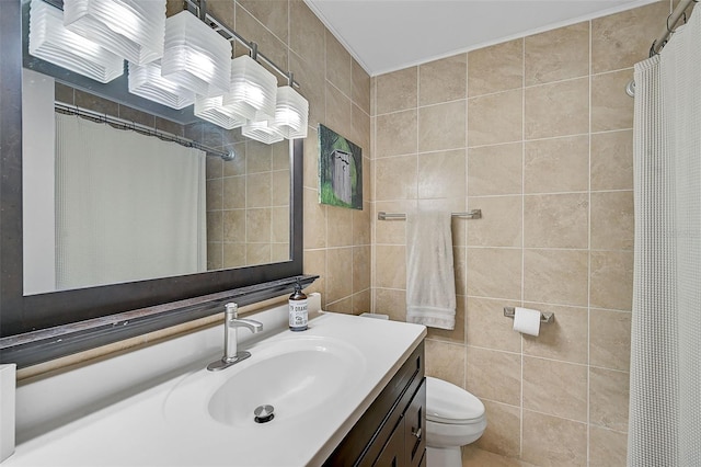 bathroom featuring toilet, a shower with curtain, vanity, and tile walls