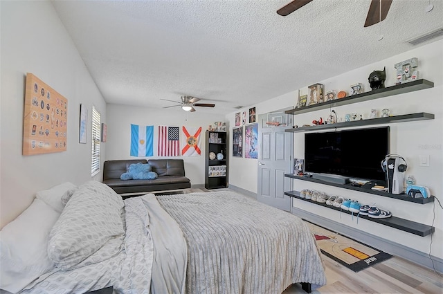 6738 Brentford Rd, Sarasota, FL 34241 - bedroom with a textured ceiling, wood finished floors, and ceiling fan