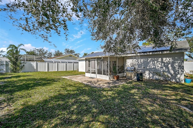 6738 Brentford Rd, Sarasota, FL 34241 - rear view of property featuring a sunroom, a fenced backyard, and solar panels