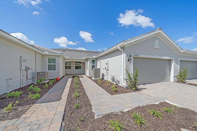 single story home with central AC and a garage