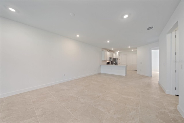 unfurnished living room with sink