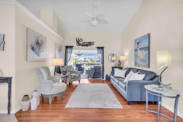 living room with hardwood / wood-style floors, ceiling fan, and lofted ceiling