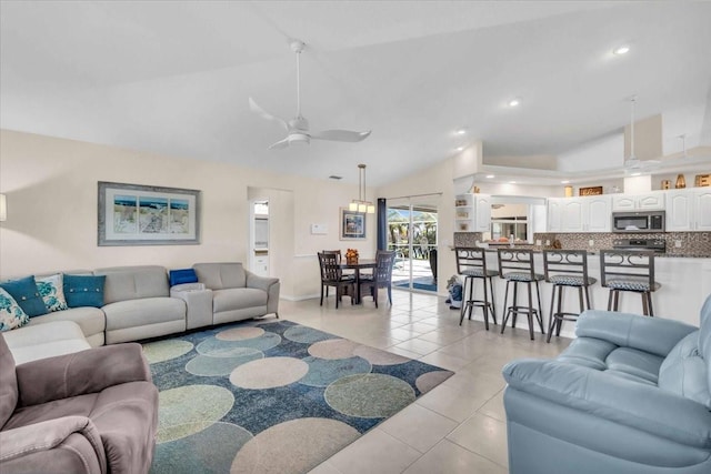 tiled living room featuring ceiling fan and lofted ceiling