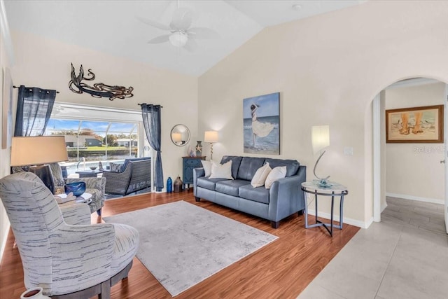 living room featuring hardwood / wood-style flooring, ceiling fan, and vaulted ceiling