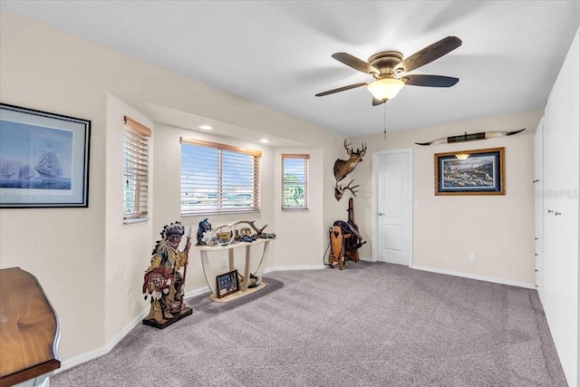 misc room with light colored carpet and ceiling fan