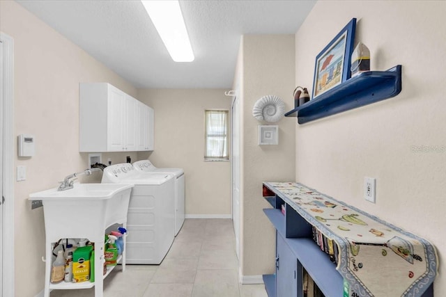 laundry area featuring light tile patterned floors, cabinets, and independent washer and dryer