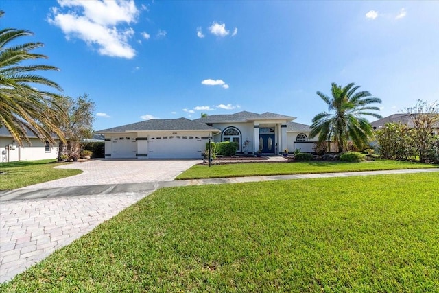 view of front of property with a garage and a front lawn