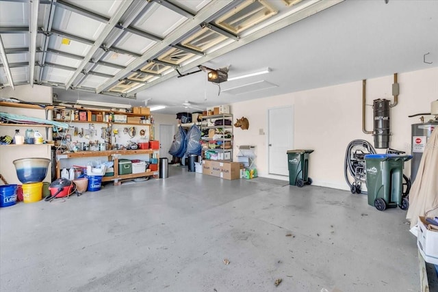 garage with a workshop area and a garage door opener