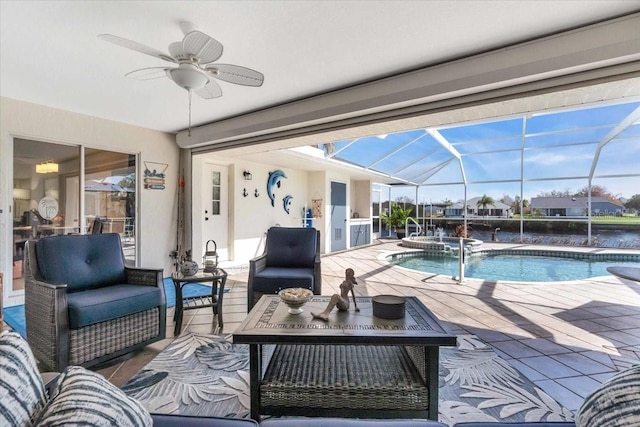 view of pool with an in ground hot tub, a patio, glass enclosure, and ceiling fan